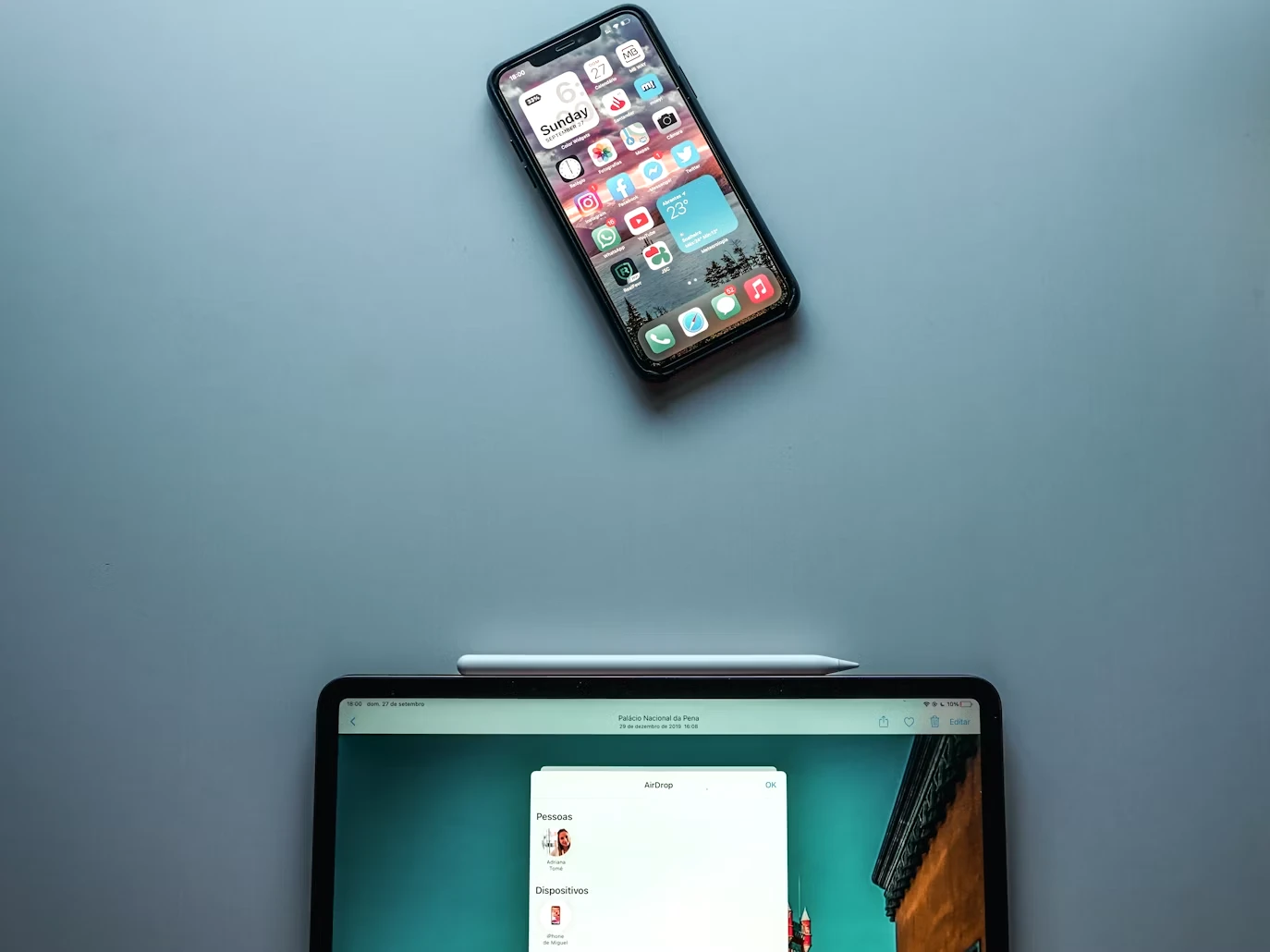 A smartphone and tablet on a minimal desk surface, representing digital tools for ADHD task management and reminders