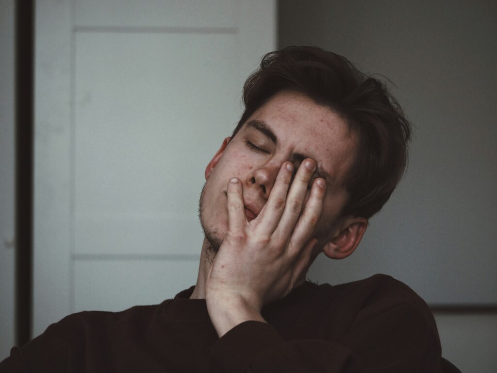 Young adult experiencing brain fog and fatigue, symptoms studied in our Long Covid pilot study