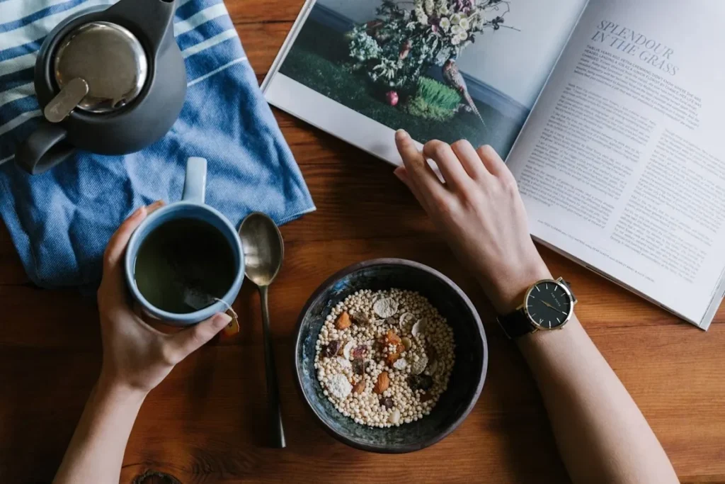 Calm morning routine with tea, breakfast, and a magazine — the daily rhythm a Long Covid memory app helps support