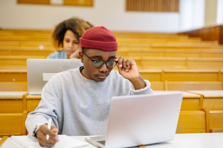 University student studying with a laptop in a lecture hall