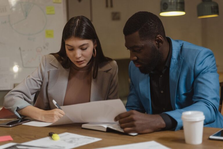 Access to Work for memory problems: two colleagues going through meeting notes together
